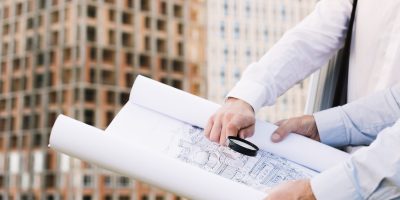 close-up-people-holding-building-sketch